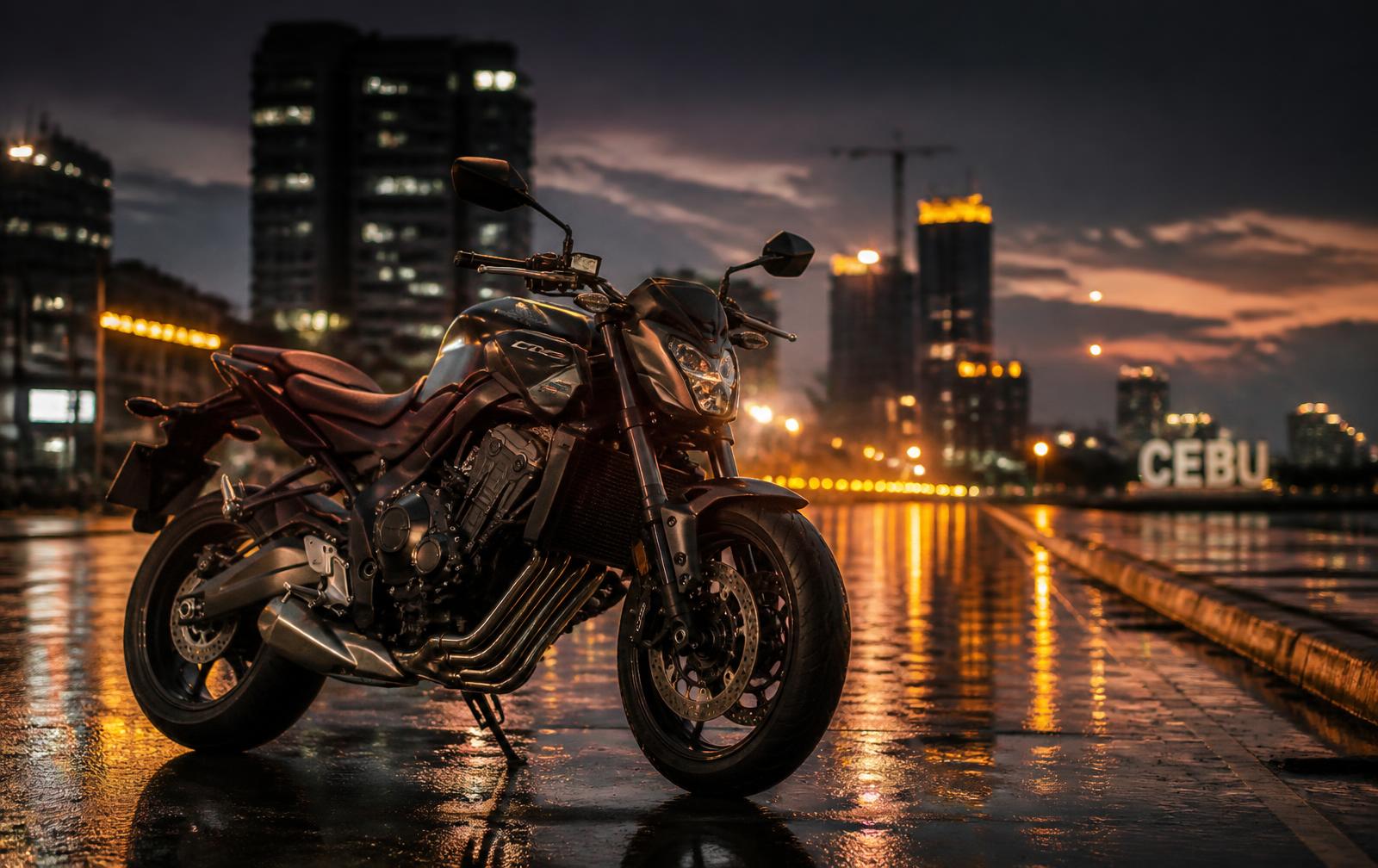 Motorcycle parked on a wet Cebu street at dusk